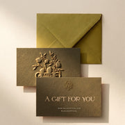 Salvē gift card with embossed pomegranate logo and olive green envelope, textured paper, gift packaging