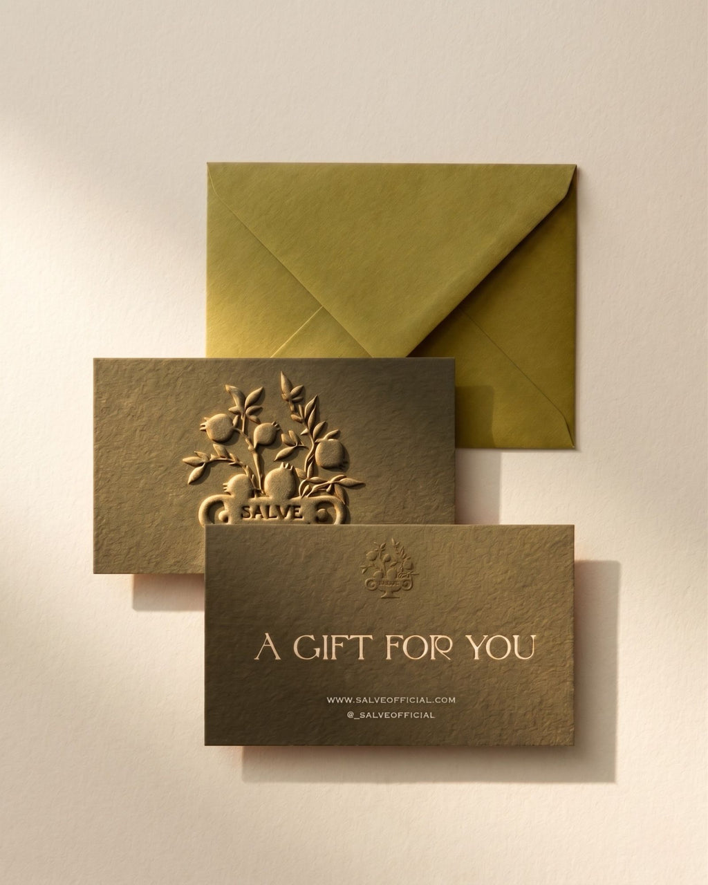 Salvē gift card with embossed pomegranate logo and olive green envelope, textured paper, gift packaging