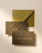 Salvē gift card with embossed pomegranate logo and olive green envelope, textured paper, gift packaging