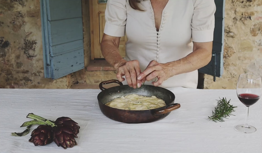 A women makes focaccia in the Tuscan countryside in the salve Thelma dress